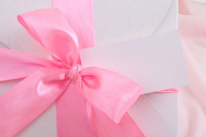 gift box with pink ribbon and blank card